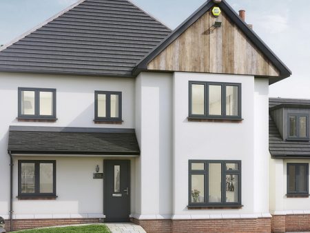 A white house with black composite windows, black door and black roof.